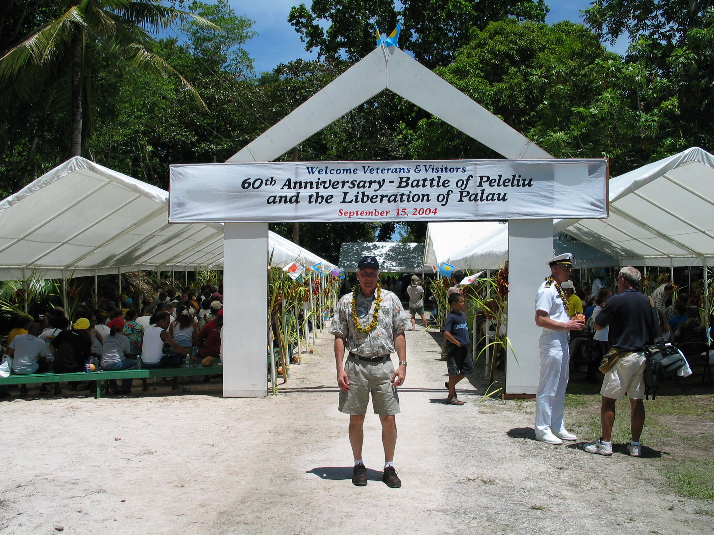 man standing in front of welcome tent
